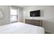 Bedroom with a king-size bed, dresser, and window at 9009 Rhodes St, Kissimmee, FL 34747