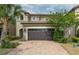 Two-story house with a brown garage door and brick driveway at 9009 Rhodes St, Kissimmee, FL 34747
