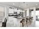 Modern kitchen with white cabinets, an island with seating, and stainless steel appliances at 9009 Rhodes St, Kissimmee, FL 34747