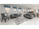 Spacious living room with gray sofas and a glass coffee table at 9009 Rhodes St, Kissimmee, FL 34747
