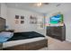 Bright bedroom with a large bed, dresser, and TV at 931 Kylee Aly, Winter Garden, FL 34787