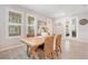 Light and airy dining room with wooden table and woven chairs at 931 Kylee Aly, Winter Garden, FL 34787