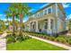 Two-story craftsman home with front porch, landscaping, and palm trees at 931 Kylee Aly, Winter Garden, FL 34787