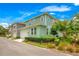 Green two-story home with attached garage and landscaped yard at 931 Kylee Aly, Winter Garden, FL 34787