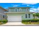 Two-story house with a white garage door and manicured landscaping at 931 Kylee Aly, Winter Garden, FL 34787