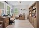 Bright home office features built-in shelving and wood desk at 931 Kylee Aly, Winter Garden, FL 34787