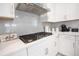 Modern kitchen with white cabinets and gas cooktop at 931 Kylee Aly, Winter Garden, FL 34787
