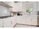 Modern kitchen features stainless steel appliances and white cabinets at 931 Kylee Aly, Winter Garden, FL 34787