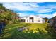 Landscaped backyard with grassy lawn and raised garden beds at 10050 Hidden Dunes Ln, Orlando, FL 32832