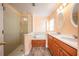 Bathroom with double vanity, garden tub, and glass shower at 10050 Hidden Dunes Ln, Orlando, FL 32832