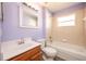 Bathroom with updated vanity, tub, and tiled walls at 10050 Hidden Dunes Ln, Orlando, FL 32832