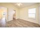 Bedroom with wood-look floors, access to bathroom, and ceiling fan at 10050 Hidden Dunes Ln, Orlando, FL 32832