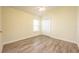 Bright bedroom featuring wood-look floors and ceiling fan at 10050 Hidden Dunes Ln, Orlando, FL 32832