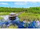 Boardwalk path and gazebo over water in a lush, natural setting at 10050 Hidden Dunes Ln, Orlando, FL 32832