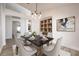 Elegant dining room with built-in shelving and a modern light fixture at 10050 Hidden Dunes Ln, Orlando, FL 32832