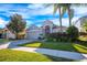 Single-story house with gray siding, attached garage, and manicured lawn at 10050 Hidden Dunes Ln, Orlando, FL 32832