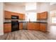 Well-equipped kitchen featuring wood cabinets and dark countertops at 10050 Hidden Dunes Ln, Orlando, FL 32832