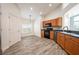 Kitchen with wood cabinets, black appliances, and tile flooring at 10050 Hidden Dunes Ln, Orlando, FL 32832