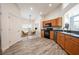 Modern kitchen with wood cabinets, stainless steel appliances, and tile flooring at 10050 Hidden Dunes Ln, Orlando, FL 32832