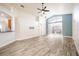 Open living room with tile floors, access to patio, and blue accent wall at 10050 Hidden Dunes Ln, Orlando, FL 32832