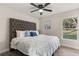 Spacious bedroom with tufted headboard and large window at 1104 W 3Rd Street, Sanford, FL 32771