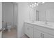 Modern bathroom with double sinks, white cabinetry, and a separate toilet room at 1123 Happy Forest Loop, Deland, FL 32720