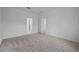 Empty bedroom featuring two entryways, neutral carpeting, and white walls at 1123 Happy Forest Loop, Deland, FL 32720