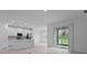Bright open-concept kitchen and living room area featuring a modern design and sliding glass doors at 1123 Happy Forest Loop, Deland, FL 32720