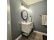 Modern bathroom with white vanity, gray walls, and updated fixtures at 116 Reserve Cir # 212, Oviedo, FL 32765