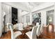 Modern dining room featuring a glass-top table and white chairs at 11618 Vinci Dr, Windermere, FL 34786