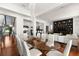 Elegant dining room with glass table, white chairs, and hardwood floors at 11618 Vinci Dr, Windermere, FL 34786