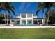 Two-story home, white exterior, lakefront property at 11618 Vinci Dr, Windermere, FL 34786