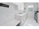 Clean laundry room with white cabinets, a built-in bench, and a washer/dryer at 11618 Vinci Dr, Windermere, FL 34786