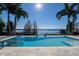 Inviting pool area with lake view and tropical landscaping at 11618 Vinci Dr, Windermere, FL 34786