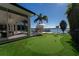 Landscaped backyard with putting green, pool, and lake view at 11618 Vinci Dr, Windermere, FL 34786