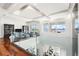Modern upper hallway with hardwood floors and glass railings overlooking the main floor and lake at 11618 Vinci Dr, Windermere, FL 34786