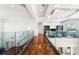 Modern upper hallway with hardwood floors and glass railings overlooking the main floor at 11618 Vinci Dr, Windermere, FL 34786