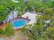 Home with a screened-in pool and lush green surroundings at 120 Crooked Pine Rd, Port Orange, FL 32128