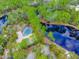 Aerial view showing home, pool, and surrounding waterways at 120 Crooked Pine Rd, Port Orange, FL 32128