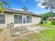 Backyard view showing patio, side of house and landscaping at 120 Crooked Pine Rd, Port Orange, FL 32128