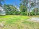 Large backyard with grassy area and privacy from trees at 120 Crooked Pine Rd, Port Orange, FL 32128