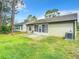 House exterior and backyard with patio and grassy area at 120 Crooked Pine Rd, Port Orange, FL 32128
