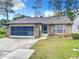 Brick ranch house with screened garage and landscaped yard at 120 Crooked Pine Rd, Port Orange, FL 32128