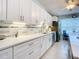 White kitchen cabinets, quartz countertops, and stainless steel appliances at 120 Crooked Pine Rd, Port Orange, FL 32128