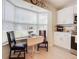 Cozy kitchen nook with white table and two black chairs at 120 Crooked Pine Rd, Port Orange, FL 32128