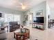 Living room with seating area, coffee table, and large TV at 120 Crooked Pine Rd, Port Orange, FL 32128