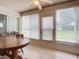 Bright sunroom with a wooden table and access to the backyard at 120 Crooked Pine Rd, Port Orange, FL 32128