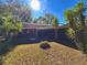 Sunny backyard with screened patio and lush landscaping at 12151 Se 86Th Ave, Belleview, FL 34420