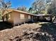 Ranch-style home with a brown exterior and landscaping at 12151 Se 86Th Ave, Belleview, FL 34420