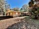 Ranch-style home with brown exterior and landscaping at 12151 Se 86Th Ave, Belleview, FL 34420